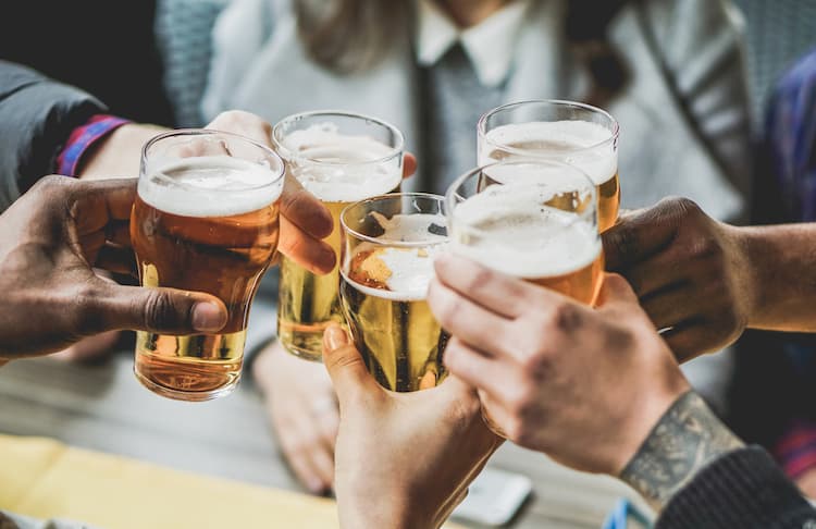 group of people toasting glasses of beer