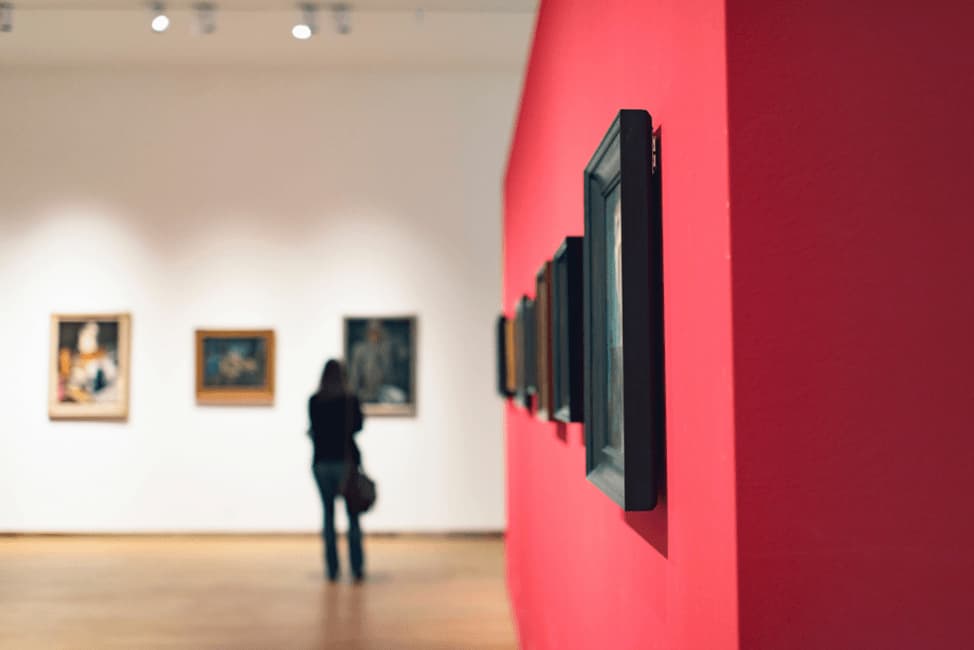 art pieces carefully arranged on a red wall at the Dallas Museum of Art