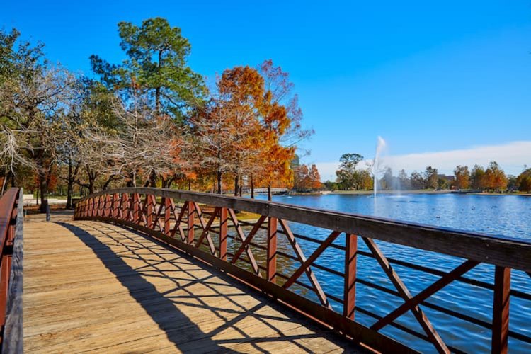 A bridge that crosses water at Hermann Park.